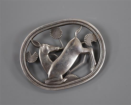 A Georg Jensen 925 oval kneeling deer brooch, designed by Arno Malinowski, design no. 256, 43mm, 12 grams.